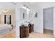 Bathroom showcasing dual vessel sinks on ornate vanities, with neutral tile and access to bedroom and closet at 2408 Sweetwater Blvd, St Cloud, FL 34772