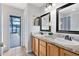 Bathroom with double sinks, vanity, framed mirrors, and access to the screened-in outdoor pool area at 2408 Sweetwater Blvd, St Cloud, FL 34772