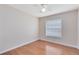 Cozy bedroom with hardwood floors, ceiling fan, and a bright window for plenty of natural light at 2408 Sweetwater Blvd, St Cloud, FL 34772