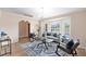 Bright living room featuring neutral paint, tile floors, and a large bay window for natural light at 2408 Sweetwater Blvd, St Cloud, FL 34772