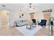 Bright living room with neutral tones, stylish furnishings, and lots of natural light from the windows at 2408 Sweetwater Blvd, St Cloud, FL 34772