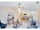 Inviting living room with ceiling fan, view of adjacent kitchen, stylish furniture, and natural light at 2408 Sweetwater Blvd, St Cloud, FL 34772