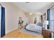 Bright main bedroom featuring neutral paint, hardwood floors, and an ensuite bathroom at 2408 Sweetwater Blvd, St Cloud, FL 34772