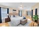 Spacious main bedroom featuring neutral paint, hardwood floors, and lots of natural light at 2408 Sweetwater Blvd, St Cloud, FL 34772