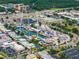 Lively aerial view of an amusement park with roller coaster and nearby buildings, landscaping and parking areas at 2606 Roadster Ln, Kissimmee, FL 34746