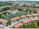 Aerial view of community showcasing the pool, clubhouse, water features and surrounding residential properties near a pond at 2606 Roadster Ln, Kissimmee, FL 34746