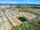 Aerial view featuring the community's layout, including the residences and a central pond surrounded by greenery at 2606 Roadster Ln, Kissimmee, FL 34746