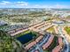 Aerial view of the residential community showcases the layout, landscaping, and surrounding natural environment at 2606 Roadster Ln, Kissimmee, FL 34746