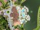 An aerial view of the community showcasing the pool, clubhouse, water features and residential properties near a pond at 2606 Roadster Ln, Kissimmee, FL 34746