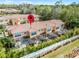 Aerial view of townhomes with screened in patios, tile roofs, and lush landscaping at 2606 Roadster Ln, Kissimmee, FL 34746