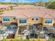 Aerial view of townhomes with screened in patios, tile roofs, and lush landscaping at 2606 Roadster Ln, Kissimmee, FL 34746