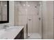 Modern bathroom with a sink, white countertop, and glass enclosed shower at 2606 Roadster Ln, Kissimmee, FL 34746