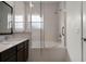 Stylish bathroom featuring a tub and shower combination with glass doors and natural light at 2606 Roadster Ln, Kissimmee, FL 34746