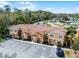 Aerial view of townhome complex near campground, showcasing front parking and landscaping at 2606 Roadster Ln, Kissimmee, FL 34746