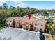 Aerial view of townhome complex near campground, showcasing front parking and landscaping at 2606 Roadster Ln, Kissimmee, FL 34746