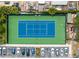 Aerial view of community tennis court featuring blue and green surface, white lines, benches, and a parking lot at 2606 Roadster Ln, Kissimmee, FL 34746