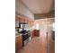 Well-lit kitchen featuring wood cabinets, stainless steel appliances, and tile flooring at 2801 Christy Ln, St Cloud, FL 34772