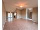 Open living room with tile flooring, a ceiling fan, and views of the kitchen and entryway at 2801 Christy Ln, St Cloud, FL 34772