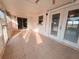 Enclosed sunroom featuring tile floors and multiple glass doors at 2801 Christy Ln, St Cloud, FL 34772