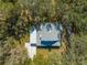 Overhead view of the home showing the roof, screened patio, carport, and the surrounding landscape at 2921 Seminole Rd, St Cloud, FL 34772