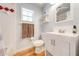 Bathroom features a window, modern vanity, gray walls, and wood floor at 2921 Seminole Rd, St Cloud, FL 34772