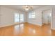 Bright bedroom with hardwood floors, ceiling fan, and glass doors to the outside at 2921 Seminole Rd, St Cloud, FL 34772