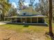 Rear view of a two-story home featuring a full-length screened in porch at 2921 Seminole Rd, St Cloud, FL 34772