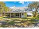 Charming cottage-style home with a screened porch and well-maintained lawn at 2921 Seminole Rd, St Cloud, FL 34772