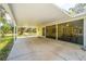 Exterior view showing a large covered carport and screened patio with seating attached to the home at 2921 Seminole Rd, St Cloud, FL 34772