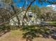 Rear angle view of the home featuring a screened-in porch and carport at 2921 Seminole Rd, St Cloud, FL 34772