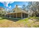 Angle view of a two-story home featuring a full-length screened in porch at 2921 Seminole Rd, St Cloud, FL 34772