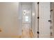 Hallway connecting to bathroom and bedroom, featuring wood flooring at 2921 Seminole Rd, St Cloud, FL 34772