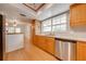 Spacious kitchen featuring wooden cabinetry, stainless steel appliances, and view to living area at 2921 Seminole Rd, St Cloud, FL 34772