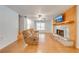 Bright living room featuring hardwood floors, a stone fireplace, and ample natural light from the large windows at 2921 Seminole Rd, St Cloud, FL 34772