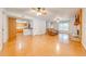 Expansive living room featuring hardwood floors, an open layout, and a view of the modern kitchen with stainless appliances at 2921 Seminole Rd, St Cloud, FL 34772