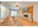 Cozy living room featuring a decorative fireplace, wood floors, and a comfortable sofa, perfect for relaxation at 2921 Seminole Rd, St Cloud, FL 34772