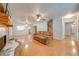 Open-concept living room featuring a decorative fireplace, hardwood floors, and access to other areas of the home at 2921 Seminole Rd, St Cloud, FL 34772