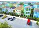 Community aerial featuring colorful homes with lush landscaping, ample parking, and tropical palms at 2958 Salted Rim Rd, Kissimmee, FL 34747