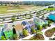 An aerial view showcases pastel colored beach homes near a community parkway at 2958 Salted Rim Rd, Kissimmee, FL 34747