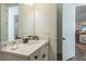 Well-lit bathroom with a clean vanity, mirror, and a glimpse of the living area at 2958 Salted Rim Rd, Kissimmee, FL 34747