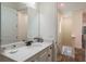 Bright bathroom featuring a granite countertop, dark bronze hardware, and wood-look tile floors at 2958 Salted Rim Rd, Kissimmee, FL 34747