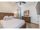 Comfortable bedroom features a wooden bed frame, wood-look tile floor and an artful palm tree wall decoration at 2958 Salted Rim Rd, Kissimmee, FL 34747