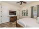 A bedroom with a TV, ceiling fan, and decorative botanical wall art at 2958 Salted Rim Rd, Kissimmee, FL 34747