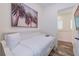 Bright bedroom with a cozy bed, wood-look tile floor and a tropical themed wall decoration at 2958 Salted Rim Rd, Kissimmee, FL 34747