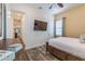 Bright bedroom featuring wood-look tile floor, ceiling fan, and a mounted TV for relaxing entertainment at 2958 Salted Rim Rd, Kissimmee, FL 34747