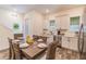 Modern dining room featuring wood-look tile floors, stainless steel appliances, and ample natural light at 2958 Salted Rim Rd, Kissimmee, FL 34747