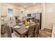 Modern dining room featuring wood-look tile floors, stainless steel appliances, and ample natural light at 2958 Salted Rim Rd, Kissimmee, FL 34747