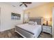 Bright main bedroom with palm tree art, side tables, and wooden floor at 2958 Salted Rim Rd, Kissimmee, FL 34747