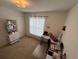 Bright bedroom with natural light, neutral carpet, and a functional workspace at 299 Chicago W Ave, Haines City, FL 33844