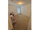 A small bedroom with tan carpet, one window, and a standard ceiling light at 299 Chicago W Ave, Haines City, FL 33844